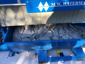 Filter cake from a stone counter top cutting operation, utilizing an M.W. Watermark filter press for wastewater treatment
