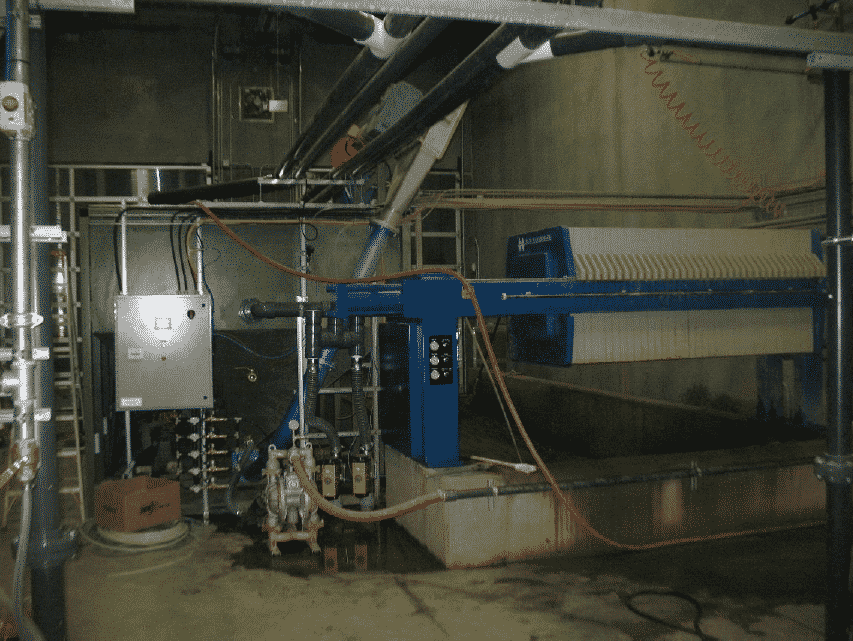 M.W. Watermark filter press, solids hopper, controls and AOD pump in a vehicle wash installation.