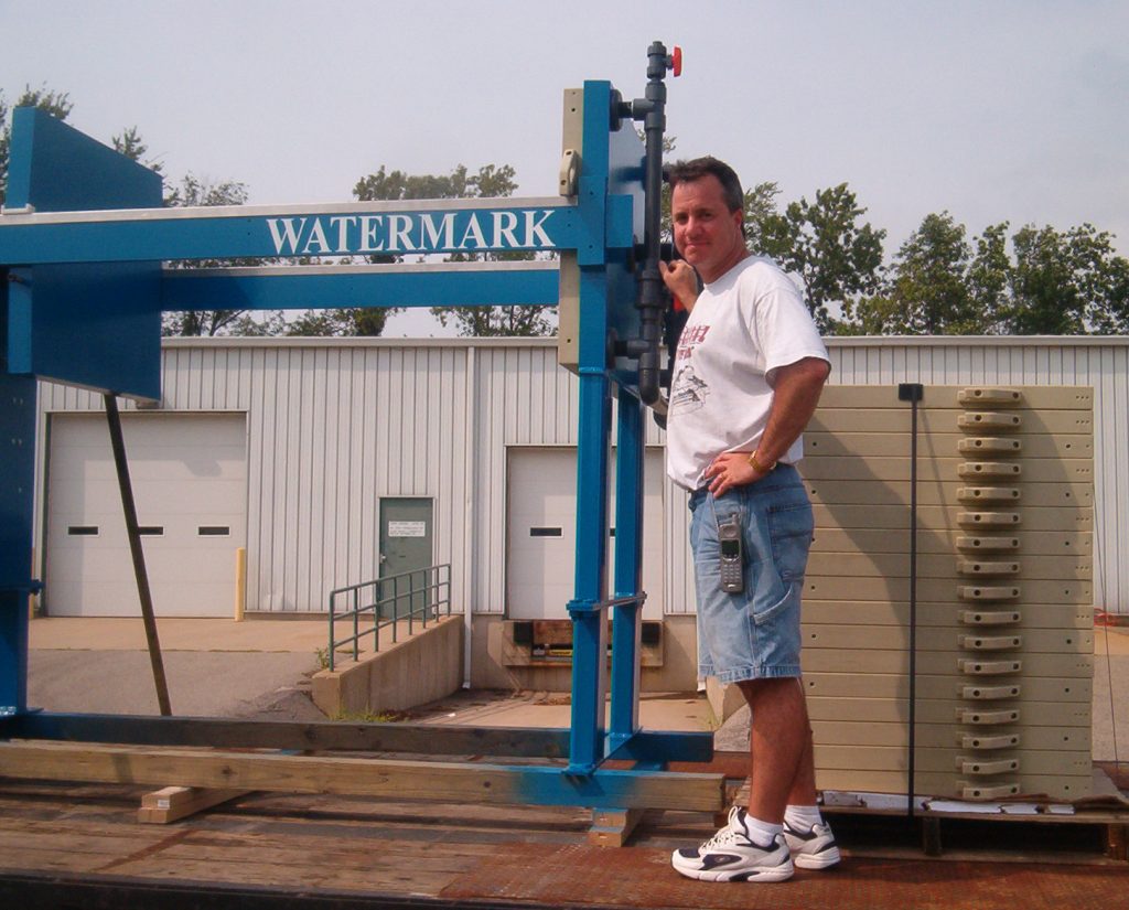 Owner / President Mike Gethin standing with one of M.W. Watermark's first filter presses - ready to ship.
