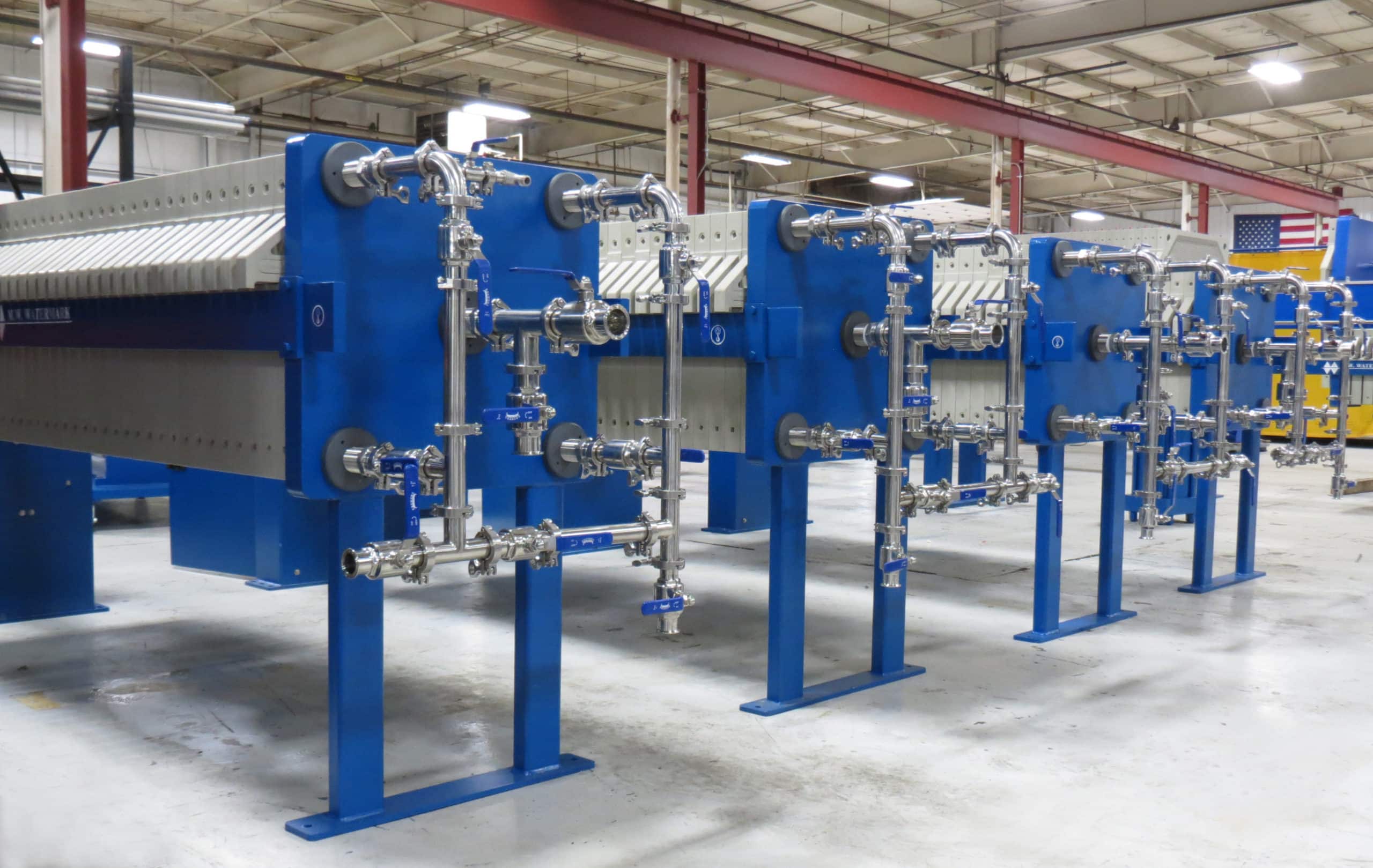 Each of these M.W. Watermark 630mm hemp oil extraction filter presses features a stainless steel manifold with tri-clamp fittings that allow for ease of disassembly when cleaning.