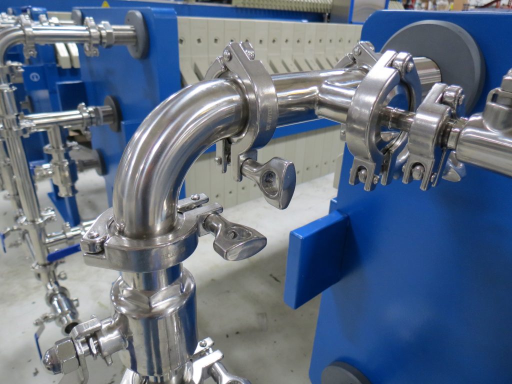 Stainless steel manifold with tri-clamp fittings that allow for ease of disassembly when cleaning.