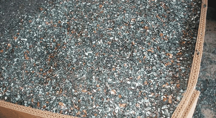 Plastic nursery trays and pots are sorted and run through a grinder. The resulting mixture of plastic chips and residual dirt is shown here. (Photo: joegardener.com)