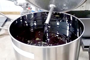 Winterization solution filtrate filling a stainless steel container. 