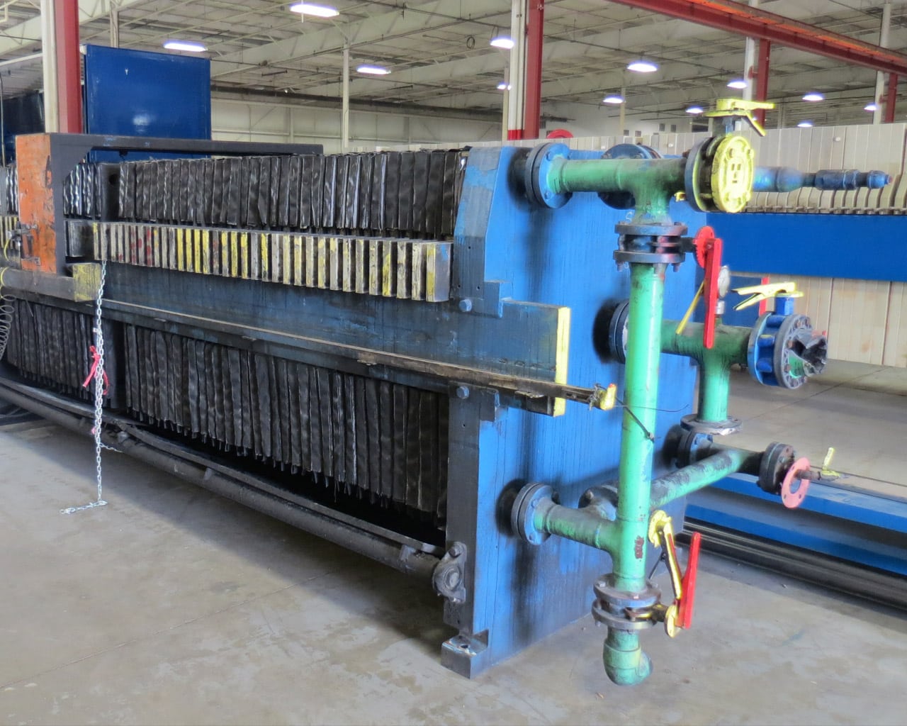 Before-shot of a Perrin Filter Press manifold and plates in disrepair