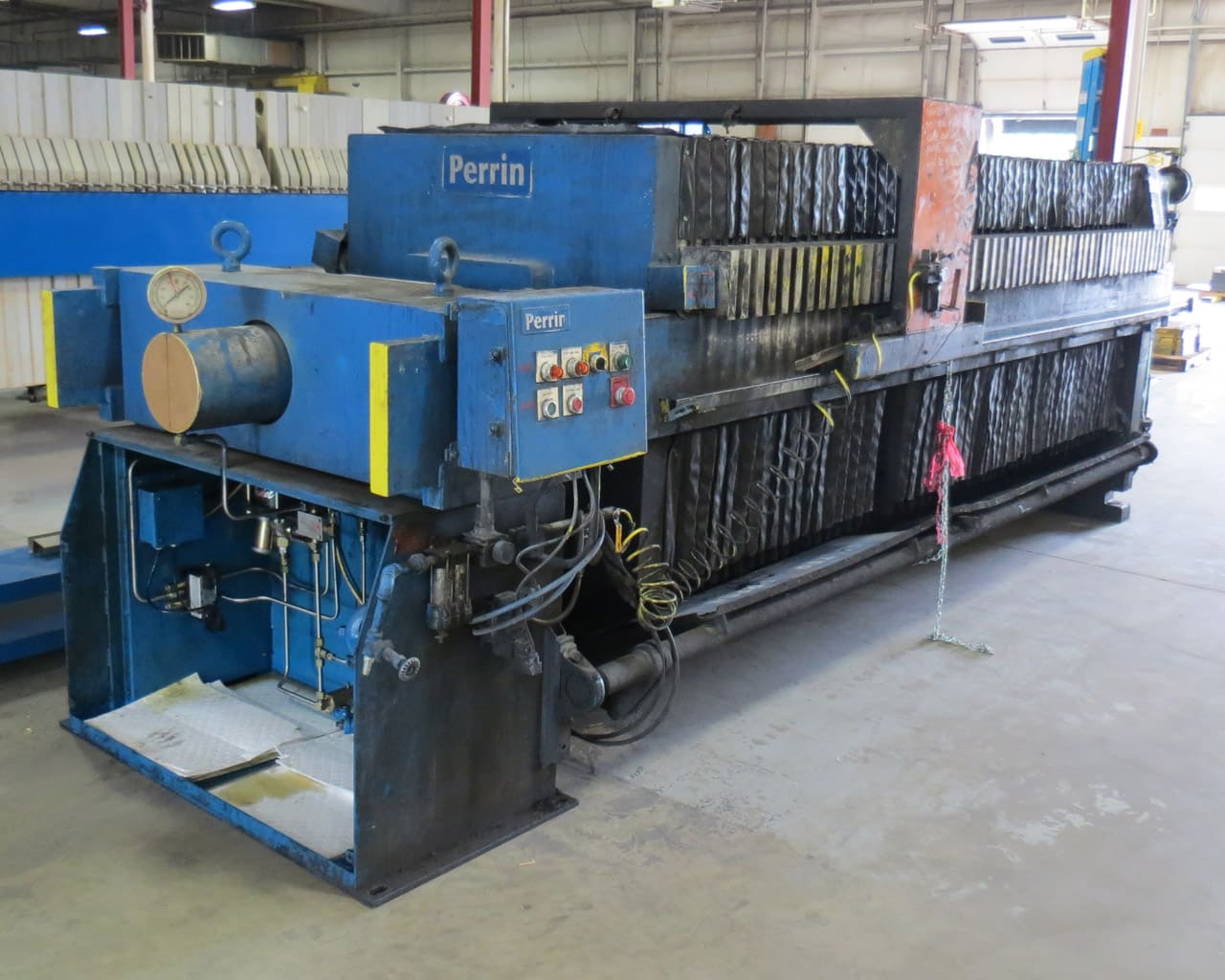 Before-shot of a Perrin Filter Press hydraulics and plates in disrepair
