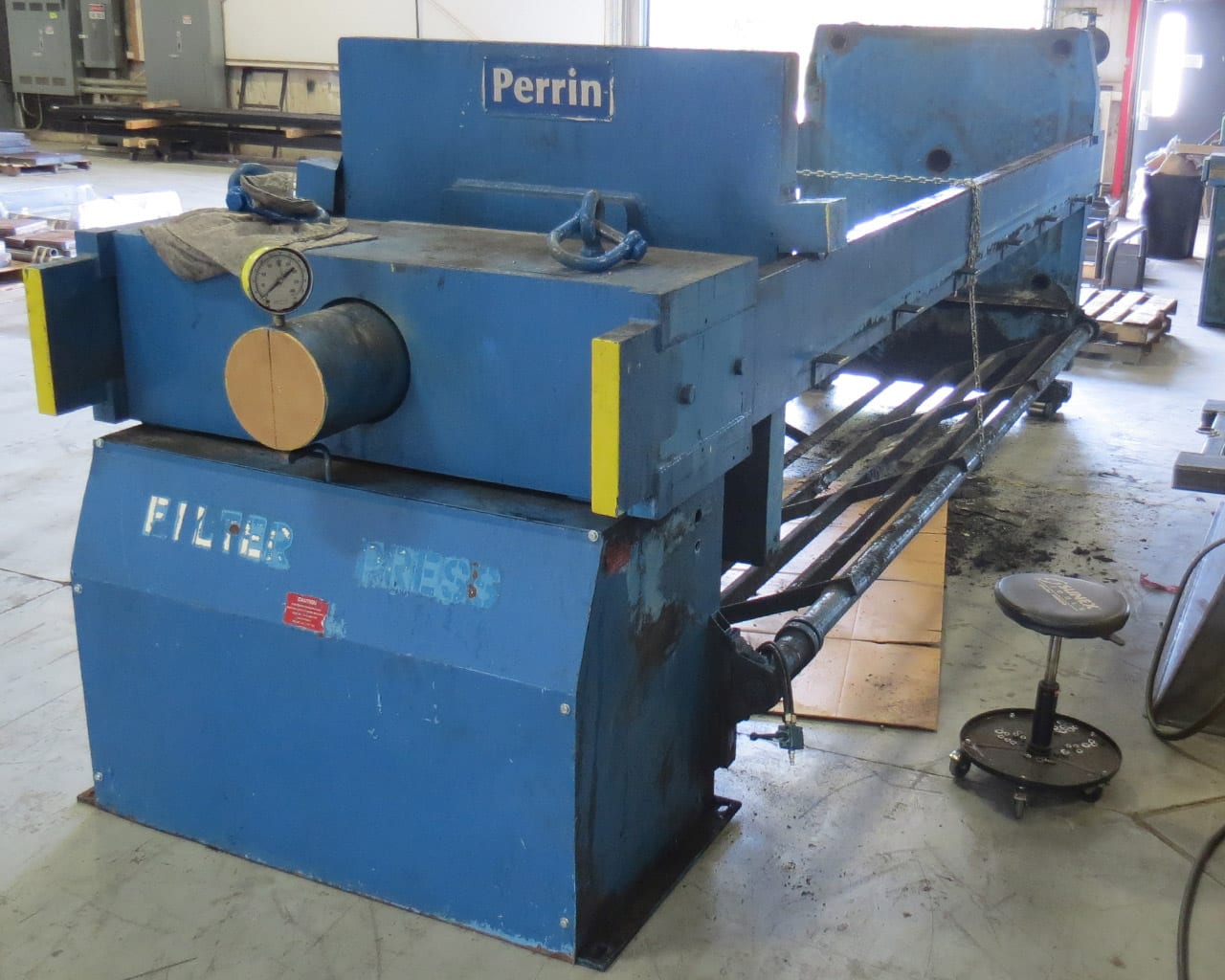 Midway-shot of a Perrin Filter Press hydraulics and plates in the middle of an M.W. Watermark rebuild